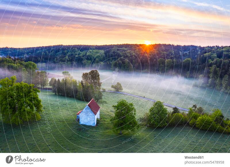 Germany, Bavaria, Egling, Drone view of Kapelle Saint Koloman at foggy springtime sunrise outdoors location shots outdoor shot outdoor shots aerial view