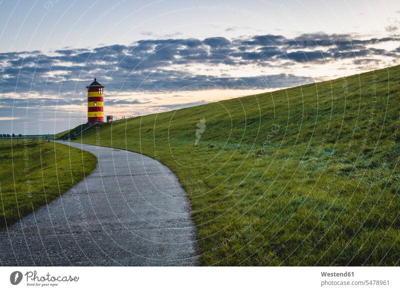 Germany, Lower Saxony, Krummhorn, Footpath leading to Pilsum Lighthouse at dusk outdoors location shots outdoor shot outdoor shots evening twilight