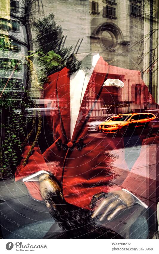 Red suit on mannequin seen through store window with reflection of building, New York, USA color image colour image outdoors location shots outdoor shot