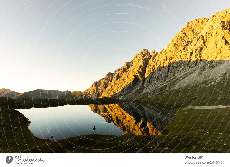 Hiker standing at Lake Kogelsee in the evening, Tyrol, Austria human human being human beings humans person persons caucasian appearance caucasian ethnicity