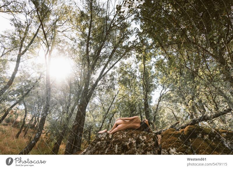 Female nude on rock in the forest relax relaxing seasons summer time summertime summery free time leisure time Lifestyle sensual Sensuality Sensuous rocks