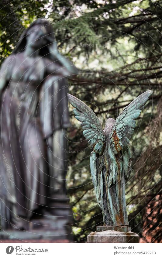 Weathered statue of angel standing outdoors location shots outdoor shot outdoor shots day daylight shot daylight shots day shots daytime Selective focus