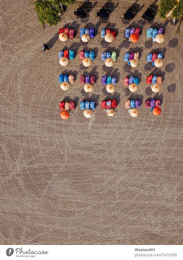 Aerial view of rows of umbrellas and deck chairs on empty Kuta Beach, Bali, Indonesia outdoors location shots outdoor shot outdoor shots day daylight shot