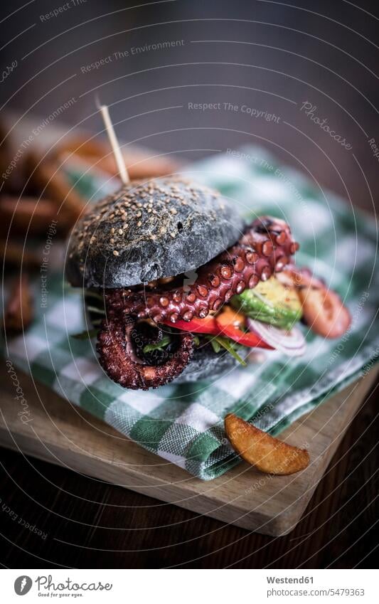 Black burger with fried octopus and vegetables indoors indoor shot Interiors indoor shots interior view skewer Selective focus Differential Focus Seafood