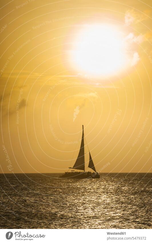 Carribbean, Aruba, Sailing boat on the sea at sunset evening mood View Vista Look-Out outlook sailing boat sailboat Sail Boat Sailboats sailing boats sky skies
