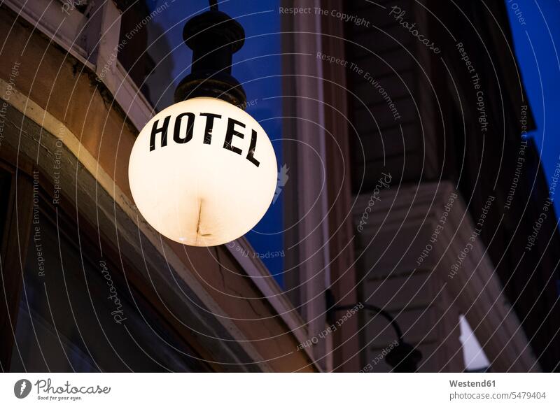 Lighted lamp with the word 'hotel' in front of facade by night Sweden low angle view worm's eye view bottom view view from below worms eye symbolical picture