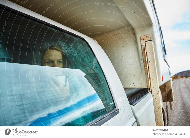 Chile, Valle Chacabuco, Parque Nacional Patagonia, woman looking out of window in camper Camping Van motor home recreational vehicle RV motor homes campervan