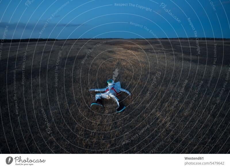 Spacewoman lying on meadow in the evening spacemen astronauts discover discovering at night by night night photography nite experience Experiences Ideas