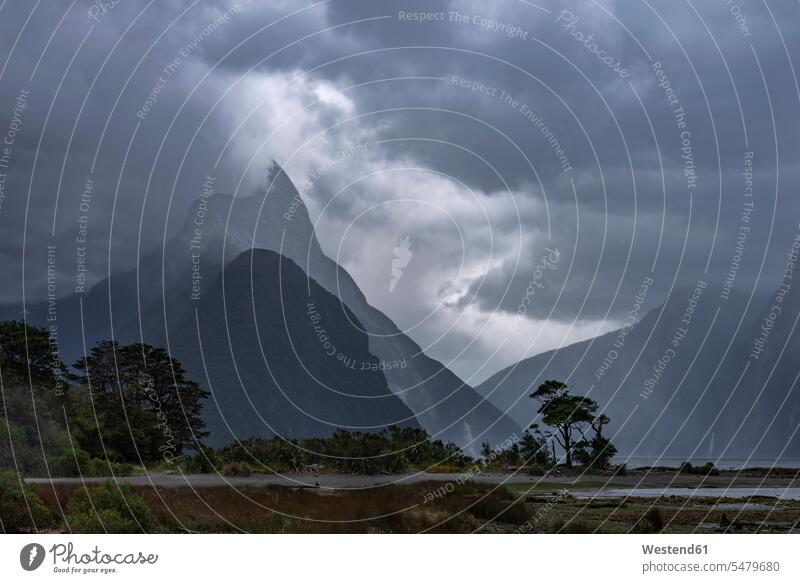 New Zealand, Southland, Gray storm clouds over Milford Sound outdoors location shots outdoor shot outdoor shots dusk evening twilight in the evening