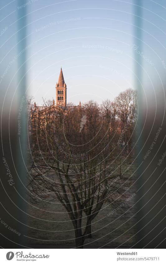 Germany, Potsdam, Dutch Quarter, Bare trees and St. Peter and Paul church seen through window outdoors location shots outdoor shot outdoor shots Architecture