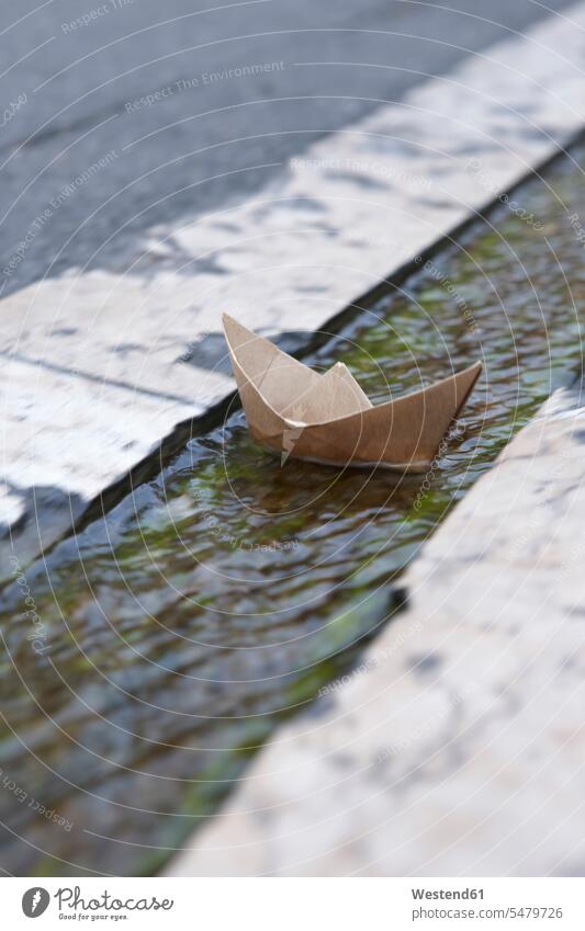 France, Paper Boat floating in gutter paper Absence Absent Objekt view Objekt views childhood paper boat paper boats ship Idea Ideas Creativity creative road