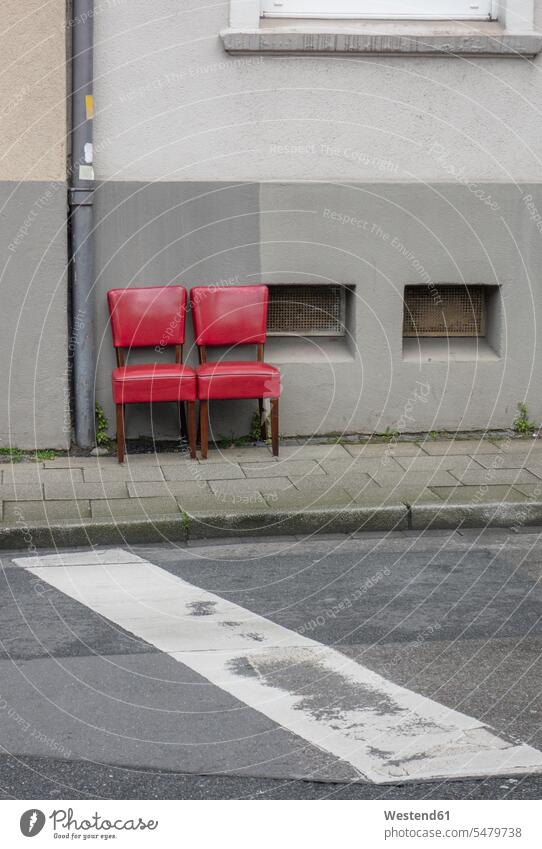 Two red old chairs standing side by side on pavement Retro retro revival Retro Styled Retro-Styled colour colours location shot location shots outdoor