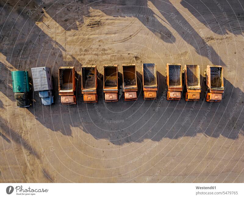 Aerial view of row of old empty trucks parked side by side outdoors location shots outdoor shot outdoor shots day daylight shot daylight shots day shots daytime
