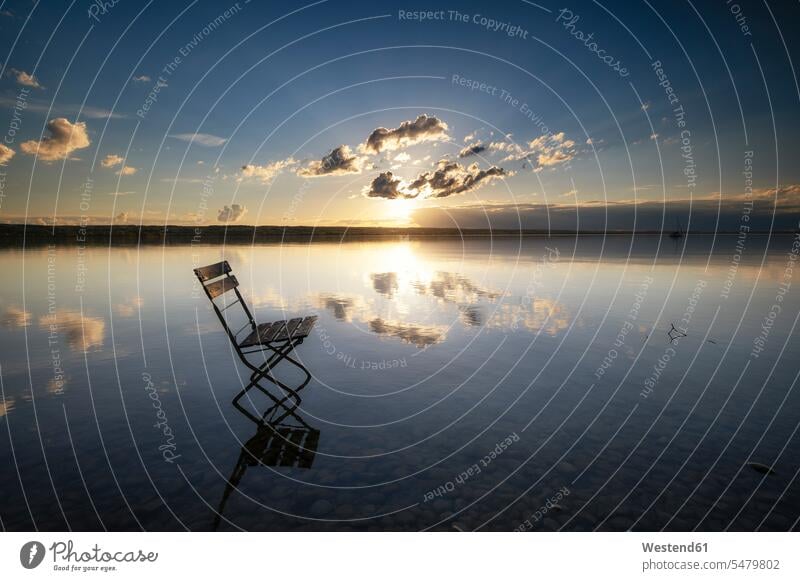 Empty chair standing in water at atmospheric sunset outdoors location shots outdoor shot outdoor shots sunsets sundown atmosphere Idyllic mood moody Vibe