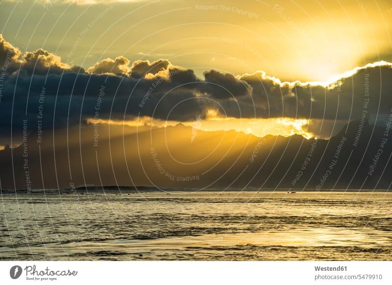 French Polynesia, Tahiti, sunrays breaking through the clouds over Moorea vastness wide Broad Far copy space wideness silhouette silhouettes tranquility