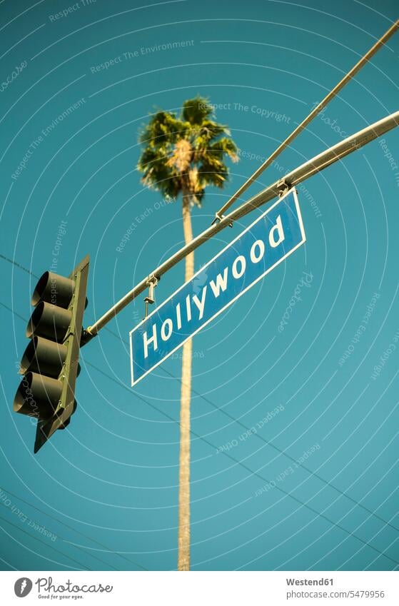 USA, California, City of Los Angeles, Stoplight with Hollywood sign hanging against clear turquoise sky outdoors location shots outdoor shot outdoor shots day