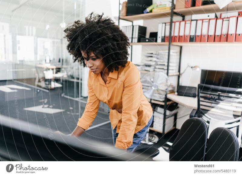 Young woman working in office standing At Work portrait portraits females women Adults grown-ups grownups adult people persons human being humans human beings