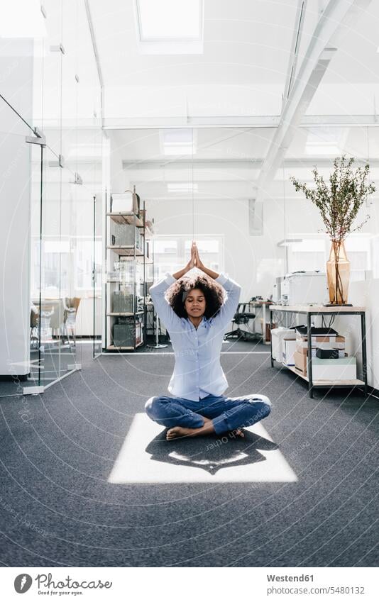 Young woman doing yoga in office females women mindfulness aware awareness self-care relaxation exercise relaxed relaxing Adults grown-ups grownups adult people