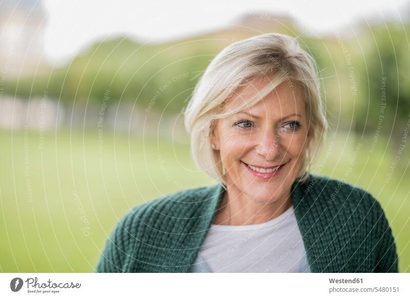 Portrait of happy senior woman in nature senior women elder women elder woman old portrait portraits laughing Laughter senior adults females Adults grown-ups