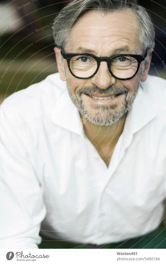 Portrait of smiling man with grey hair and beard wearing spectacles glasses specs Eye Glasses Eyeglasses portrait portraits men males Adults grown-ups grownups