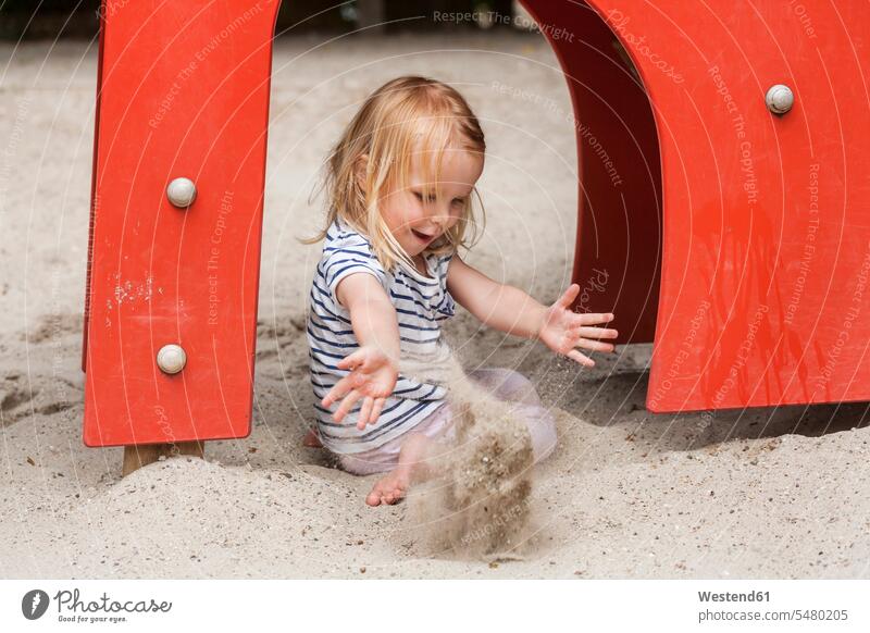 Blond little girl in sandbox on playground females girls sandpits sand-box sandboxes sand-boxes child children kid kids people persons human being humans
