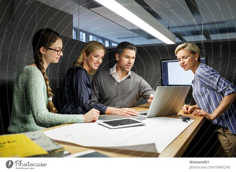 Colleagues with laptop having a meeting in meeting box Business Meeting business conference colleagues business people businesspeople office offices office room