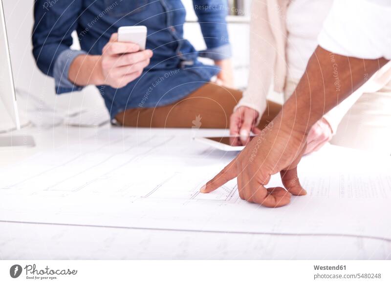 Hand pointing on construction plan hand human hand hands human hands point at pointing at show showing Blueprint Blueprints Building Plan architectural drawing