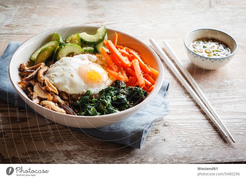 Vegetarian korean rice bowl with mushroom, spinach, cucumber, carrot and fried egg food and drink Nutrition Alimentation Food and Drinks mushrooms