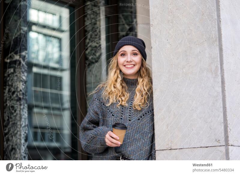 Portrait of fashionable young woman with coffee to go in autumn females women portrait portraits fall Coffee to Go takeaway coffee Adults grown-ups grownups