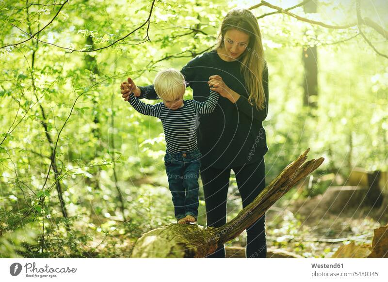 Mother and son in forest balancing balance woods forests mother mommy mothers ma mummy mama playing baby boys male Balance Equilibrium balanced parents family