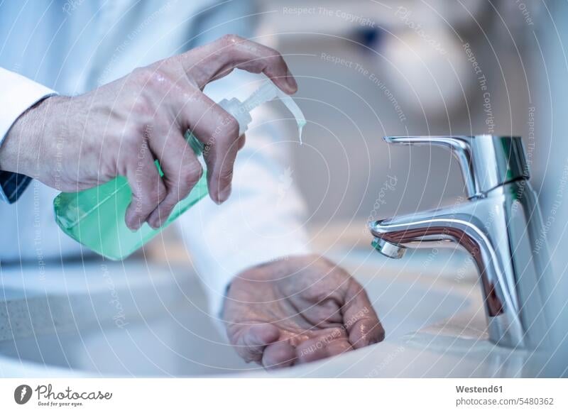 Doctor washing hands with soap doctor physicians doctors human hand human hands hygiene bathroom sink basin basins healthcare and medicine medical