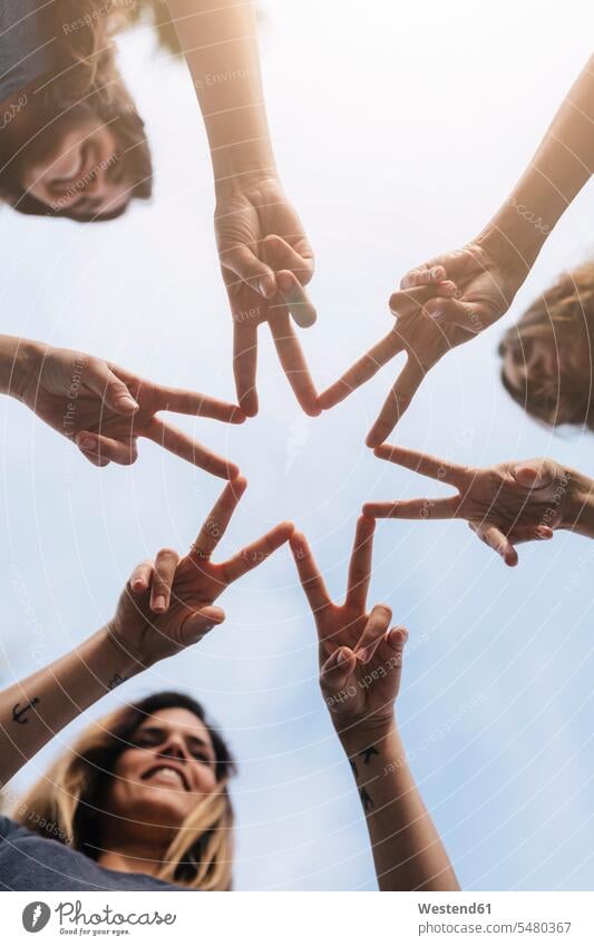 Three women shaping a star with their hands Star Shape Star Shapes Star Shaped star-shaped stars female friends community Companionship human hand human hands