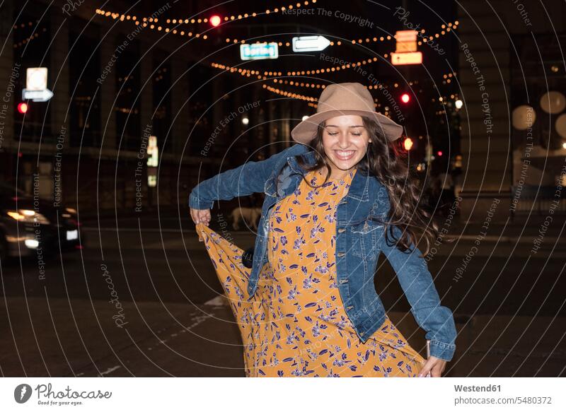 Happy young woman on the street at night smiling smile by night nite night photography dancing dance females women Adults grown-ups grownups adult people