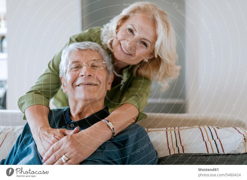 Portrait of affectionate senior couple at home senior men senior man elder man elder men senior citizen smiling smile couch settee sofa sofas couches settees