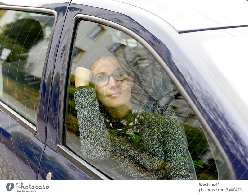 Woman looking through car window automobile Auto cars motorcars Automobiles woman females women motor vehicle road vehicle road vehicles motor vehicles