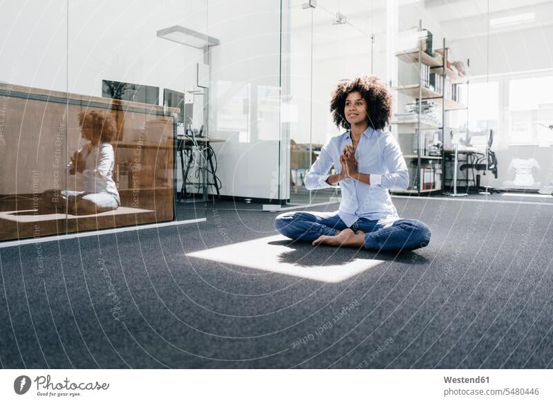 Young woman doing yoga in office females women mindfulness aware awareness self-care relaxation exercise relaxed relaxing Adults grown-ups grownups adult people