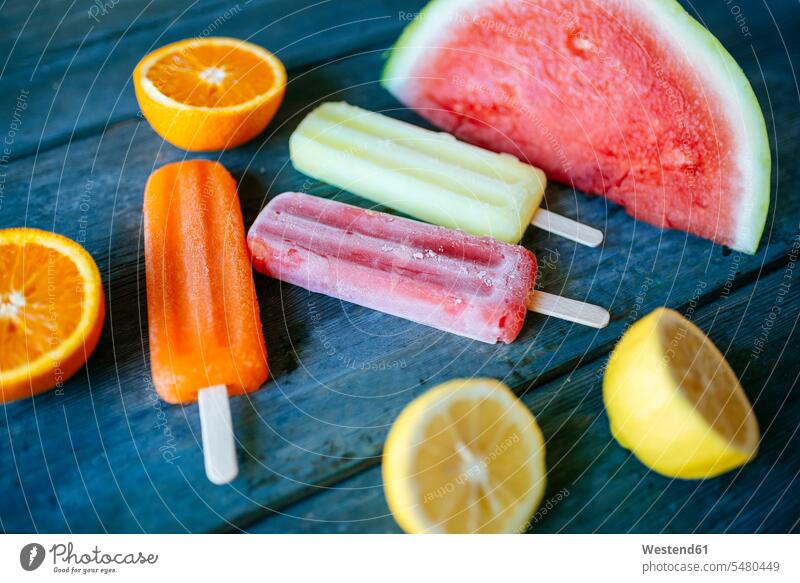 Orange, lemon and watermelon snow ice cream on blue wood cold Cold Weather Cold Temperature chilly variation frozen sweet Sugary sweets fruit various different