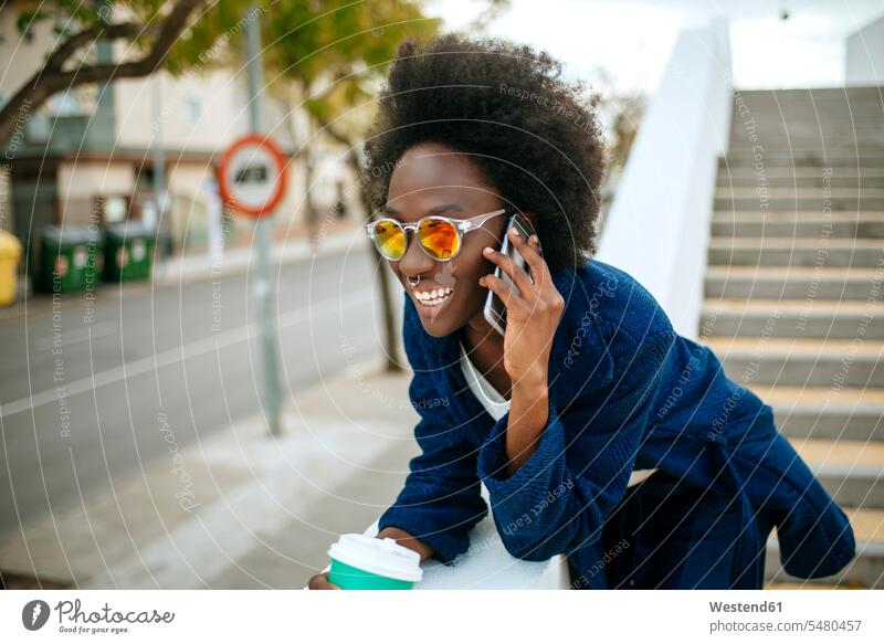 Portrait of young woman wearing mirrored sunglasses talking on mobile phone Spain Coffee to Go takeaway coffee beautiful Smartphone iPhone Smartphones