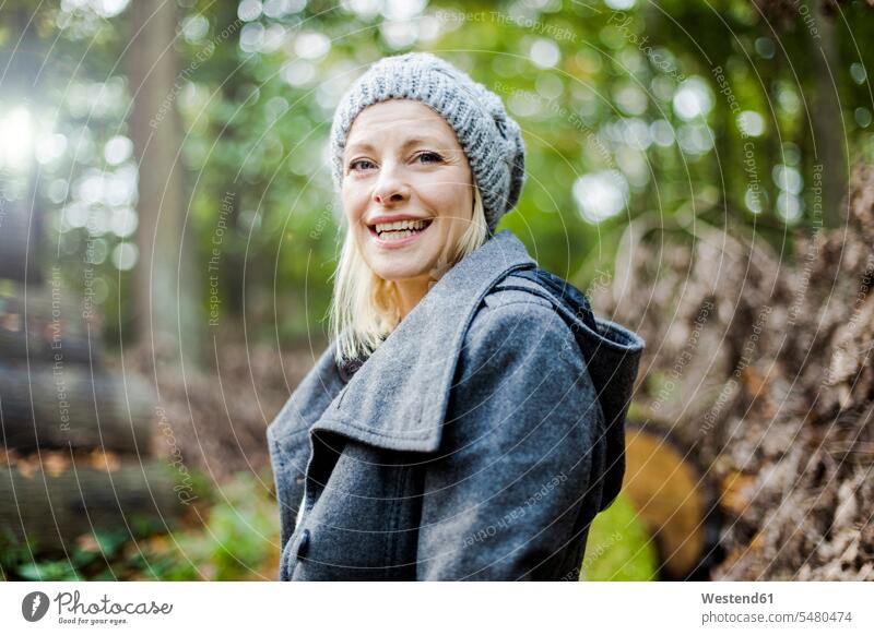 Portrait of happy woman in the forest in autumn smiling smile portrait portraits females women Adults grown-ups grownups adult people persons human being humans