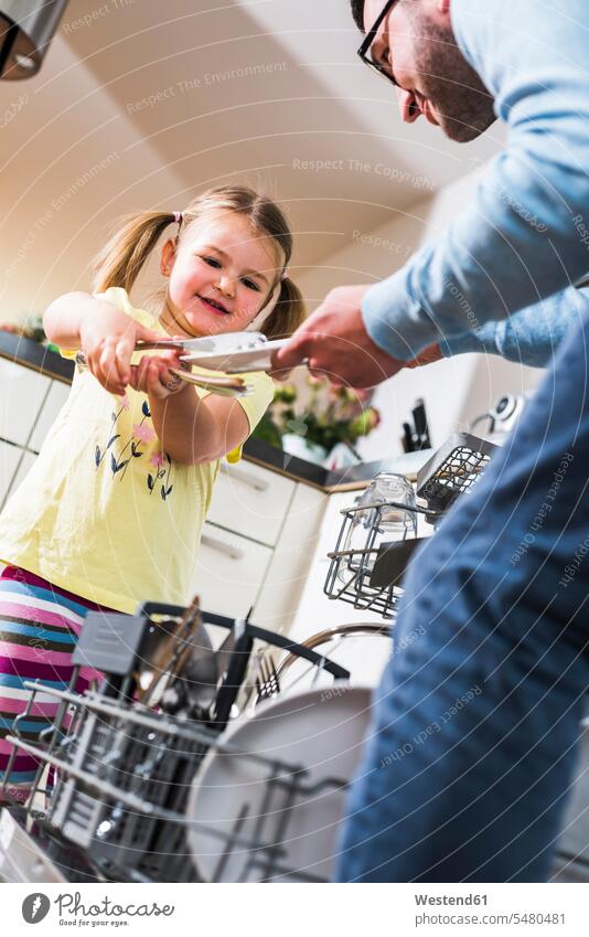 Daughter helping father clearing dishwasher smiling smile daughter daughters pa fathers daddy dads papa child children family families people persons