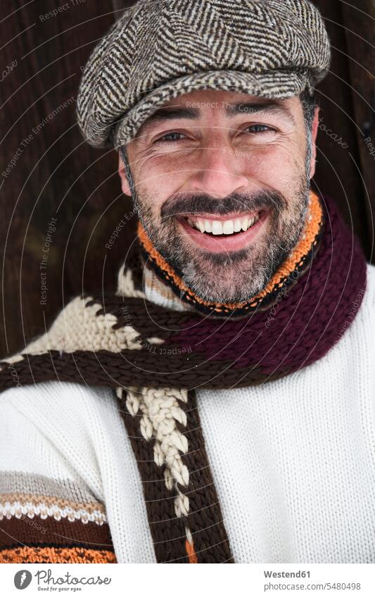 Portrait of bearded man wearing cap and scarf in winter hibernal men males portrait portraits Adults grown-ups grownups adult people persons human being humans