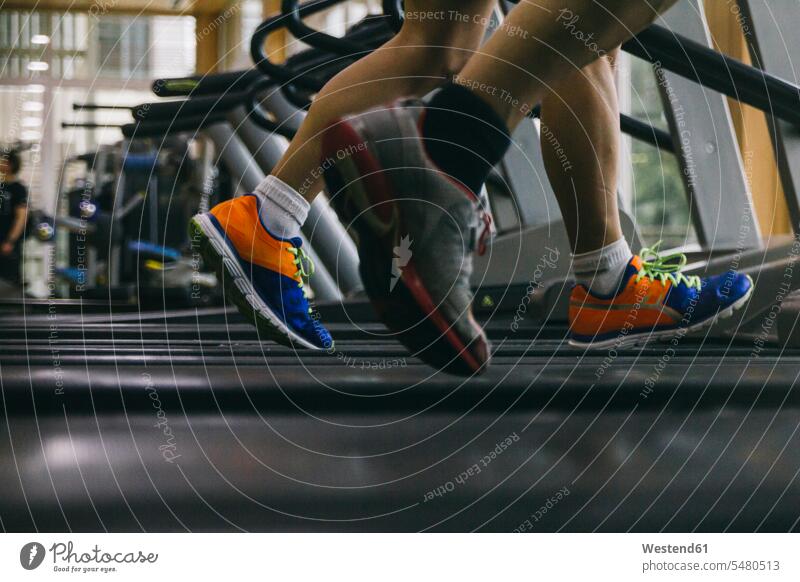 Legs of man running on a treadmill mature men mature man mid adult men mid adult man mid-adult men mid-adult man males Adults grown-ups grownups people persons