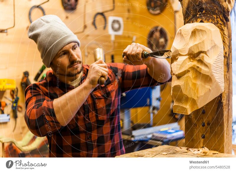 Wood carver manufacturing traditional Krampus mask Incubus mask Carver masks sculptor sculptors working At Work Carving whittling chisel chisels sculpture