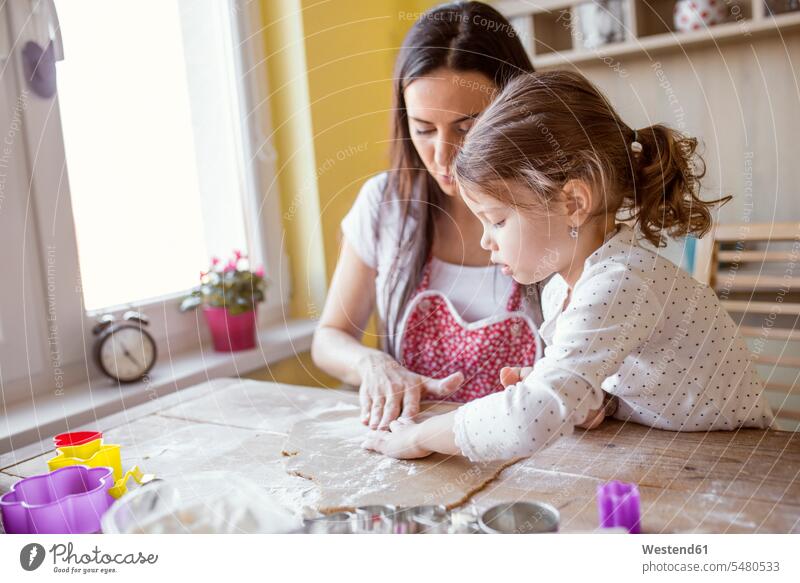 Mother and little daughter baking together caucasian caucasian ethnicity caucasian appearance european casual leisure wear casual clothing casual wear