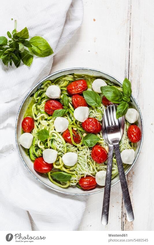 Zoodles Caprese, spiralized zucchini, glass noodles, pesto, plum tomatoe, mozarella balls Bowl Bowls uncooked garnished ready to eat ready-to-eat Raw Food
