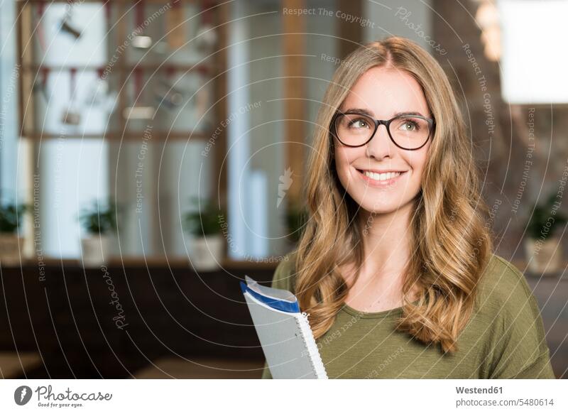 Portrait of smiling blond woman with notebook in a coffee shop smile cafe females women portrait portraits Adults grown-ups grownups adult people persons