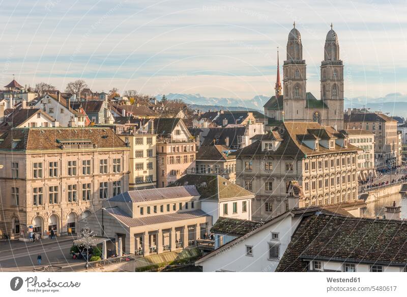 Switzerland, Zurich, view to Great Minster and Alps in the background sunlight Sunlit nobody Church Spire Steeples historical history Travel destination