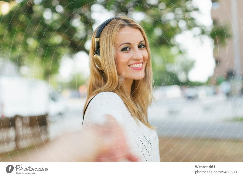 Portrait of smiling blond woman with headphones females women portrait portraits Adults grown-ups grownups adult people persons human being humans human beings