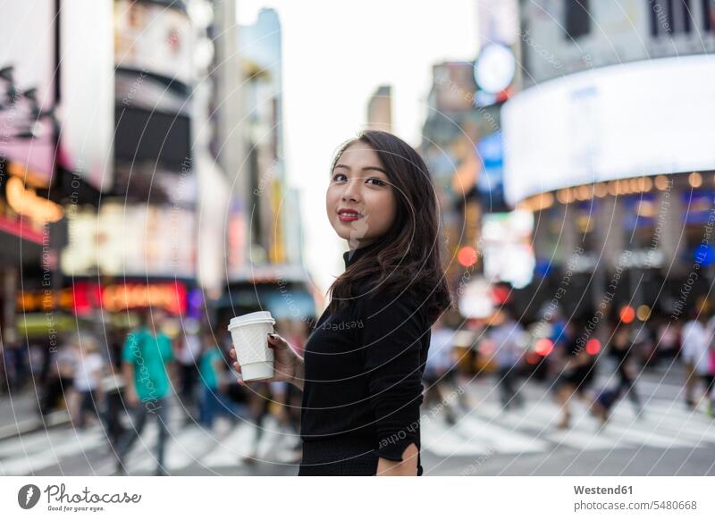 USA, New York City, Manhattan, young woman with coffee to go on the street portrait portraits females women Coffee to Go takeaway coffee Adults grown-ups