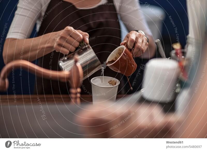 Barista preparing iced coffee pouring Cup Cups cafe Milk Coffee Drink beverages Drinks Beverage food and drink Nutrition Alimentation Food and Drinks caucasian